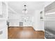 Bright, modern kitchen with white cabinetry, stainless steel appliances, and hardwood floors at 4375 Creek Ave, Midland, NC 28107