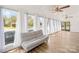 Sunroom with hardwood floors, large windows draped with white curtains, and comfortable seating at 4375 Creek Ave, Midland, NC 28107