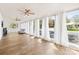 Spacious sunroom with hardwood floors, multiple windows providing ample natural light, and ceiling fans at 4375 Creek Ave, Midland, NC 28107
