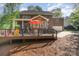 Expansive backyard with a deck featuring outdoor seating and dining, perfect for enjoying the outdoors at 4511 Morning Dove Ct, Denver, NC 28037