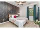 Charming bedroom showcases a floral accent wall, ceiling fan, and natural light at 4511 Morning Dove Ct, Denver, NC 28037