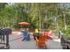 Inviting deck area with colorful Adirondack chairs, a fire pit, and a dining set, perfect for outdoor entertaining at 4511 Morning Dove Ct, Denver, NC 28037