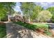 Well-manicured front yard and long driveway leading up to a beautiful brick home, showcasing its curb appeal at 4511 Morning Dove Ct, Denver, NC 28037