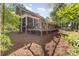 Back exterior of home with a large deck and outdoor seating area surrounded by lush landscaping at 4511 Morning Dove Ct, Denver, NC 28037