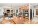 Well-designed kitchen featuring stainless steel appliances, wood cabinets, island, and connects to the inviting living area at 4511 Morning Dove Ct, Denver, NC 28037