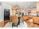 Bright kitchen with stainless steel appliances, wood cabinets, black countertop island, and a charming breakfast nook at 4511 Morning Dove Ct, Denver, NC 28037