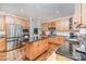 Updated kitchen boasts stainless appliances, wood cabinets, granite countertop island, with an airy, functional design at 4511 Morning Dove Ct, Denver, NC 28037