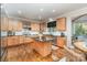 Open kitchen with stainless appliances, wood cabinets, granite counters, and a center island, perfect for entertaining at 4511 Morning Dove Ct, Denver, NC 28037