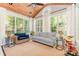 Relaxing sunroom filled with natural light, featuring vaulted wood ceiling and comfortable seating, perfect for leisure at 4511 Morning Dove Ct, Denver, NC 28037