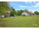This backyard features a large yard, an outbuilding, and a fire pit area with Adirondack chairs at 481 Union Cemetery Sw Rd, Concord, NC 28027