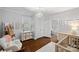 This light and airy Bedroom features hardwood floors, a chandelier and closet storage at 481 Union Cemetery Sw Rd, Concord, NC 28027