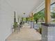 Spacious covered front porch with seating, columns, and hanging plants at 481 Union Cemetery Sw Rd, Concord, NC 28027