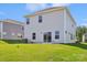 The backyard featuring lush lawn, siding of the house, and sliding glass doors at 5016 Poplin Vly, Cherryville, NC 28021