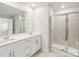 Well-lit bathroom featuring double vanity and a large glass-enclosed shower at 5016 Poplin Vly, Cherryville, NC 28021
