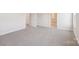 Bright bedroom with gray carpet, white trim, and an open door to a bathroom at 5016 Poplin Vly, Cherryville, NC 28021