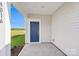 Blue front door with digital keypad and porch, leading to serene outdoor view at 5016 Poplin Vly, Cherryville, NC 28021