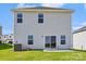 Back exterior of home featuring modern siding, windows, and sliding glass door to patio at 5016 Poplin Vly, Cherryville, NC 28021