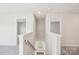 Upstairs hallway with neutral carpet, white walls and doors at 5016 Poplin Vly, Cherryville, NC 28021