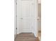 Hallway with hardwood flooring, neutral paint, and a white paneled door at 5016 Poplin Vly, Cherryville, NC 28021