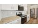 Modern kitchen features stainless steel appliances, white cabinets, and elegant granite countertops, blending style and function at 5016 Poplin Vly, Cherryville, NC 28021
