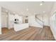 Open-concept living space with hardwood floors, white walls, and a kitchen island, offering a bright and modern feel at 5016 Poplin Vly, Cherryville, NC 28021
