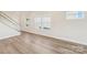 Living room featuring hardwood flooring, white walls and trim, and multiple windows at 5016 Poplin Vly, Cherryville, NC 28021