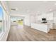 Open-concept living area with luxury vinyl plank flooring, windows, and a modern kitchen at 5016 Poplin Vly, Cherryville, NC 28021