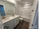 Bright bathroom with dual sink vanity and a white tub-shower combination at 5100 Verona Rd # 96, Charlotte, NC 28213