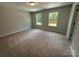 Neutral carpeted room with two windows; natural lighting at 5100 Verona Rd # 96, Charlotte, NC 28213