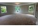 Spacious carpeted room with three windows providing ample natural light at 5100 Verona Rd # 96, Charlotte, NC 28213