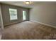 Neutral carpeted room with one window and access to outdoor area at 5100 Verona Rd # 96, Charlotte, NC 28213