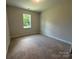 Bright bedroom with neutral carpet, a large window, and ample space at 5100 Verona Rd # 96, Charlotte, NC 28213