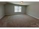 Large bedroom featuring new carpet, a large window, and neutral paint at 5100 Verona Rd # 96, Charlotte, NC 28213
