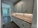 Elegant butler's pantry featuring white cabinets, decorative backsplash, and sleek countertops at 5100 Verona Rd # 96, Charlotte, NC 28213