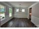 Open dining room showcasing wood-look floors, abundant natural light, wainscoting, and a modern light fixture at 5100 Verona Rd # 96, Charlotte, NC 28213