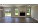 Cozy living room featuring a modern fireplace, large windows, and sliding glass doors to the backyard at 5100 Verona Rd # 96, Charlotte, NC 28213