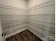 Walk-in pantry with white wire shelving and wood-look floors providing ample storage space at 5100 Verona Rd # 96, Charlotte, NC 28213