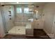 New shower featuring glass doors, tiled walls, and a built-in bench at 5100 Verona Rd # 96, Charlotte, NC 28213