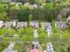 A drone view shows the house and neighborhood with lush green trees in a natural setting at 512 Red Oak Ct, Tega Cay, SC 29708
