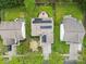Aerial view of home with solar panels, well-manicured lawn, and surrounding trees at 512 Red Oak Ct, Tega Cay, SC 29708
