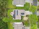 An aerial view shows a home with solar panels, a fire pit, landscaping, and a backyard at 512 Red Oak Ct, Tega Cay, SC 29708