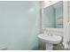 Cozy half bathroom featuring light blue walls, a vanity with a white sink and vintage mirror at 512 Red Oak Ct, Tega Cay, SC 29708