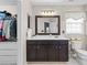 Bathroom features a dark wood vanity, white countertop and a large mirror with an attached closet at 512 Red Oak Ct, Tega Cay, SC 29708