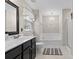 Bathroom features a tub, a vanity with dark cabinets and light counter tops plus an overhead chandelier at 512 Red Oak Ct, Tega Cay, SC 29708