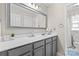 Bathroom featuring a large mirror, gray vanity, and modern fixtures at 512 Red Oak Ct, Tega Cay, SC 29708