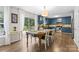 Charming eat-in kitchen featuring hardwood floors, wooden table, and bright-blue cabinetry at 512 Red Oak Ct, Tega Cay, SC 29708