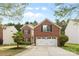 Traditional two-story brick home featuring a well-manicured lawn and an attached two-car garage at 512 Red Oak Ct, Tega Cay, SC 29708
