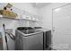 Laundry room with modern Samsung washer and dryer and wire shelving for storage at 512 Red Oak Ct, Tega Cay, SC 29708