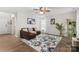 Cozy living room featuring hardwood floors, a ceiling fan, and a decorative floral area rug at 512 Red Oak Ct, Tega Cay, SC 29708