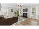 Bright and airy living room featuring a fireplace, hardwood floors, and large sun-filled windows at 512 Red Oak Ct, Tega Cay, SC 29708